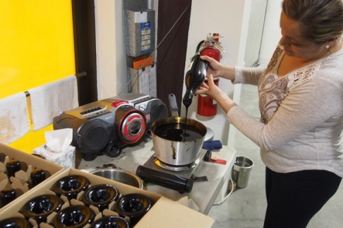 applying wax to a wine bottle